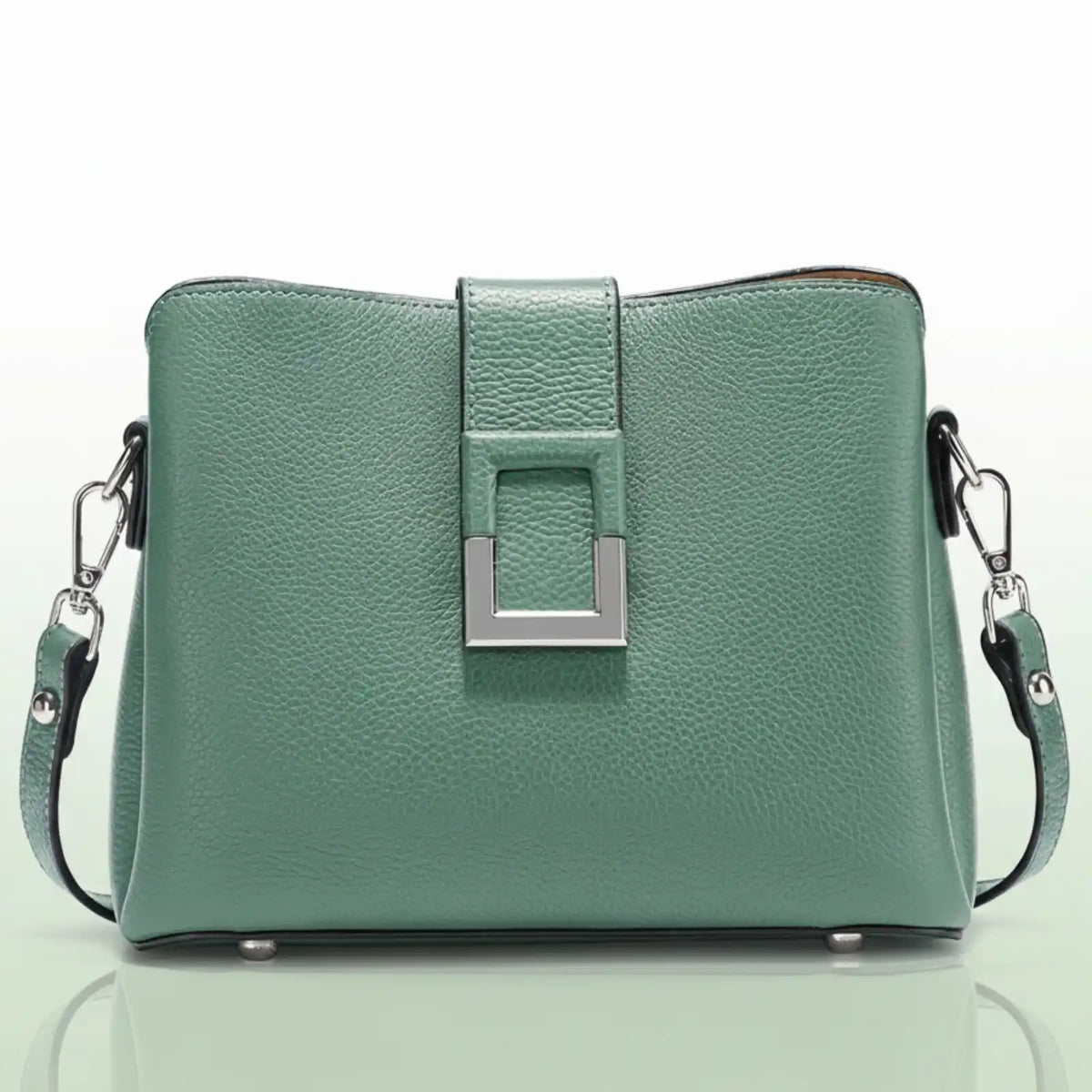 The main subject is a light green handbag. It has a textured leather-like surface.